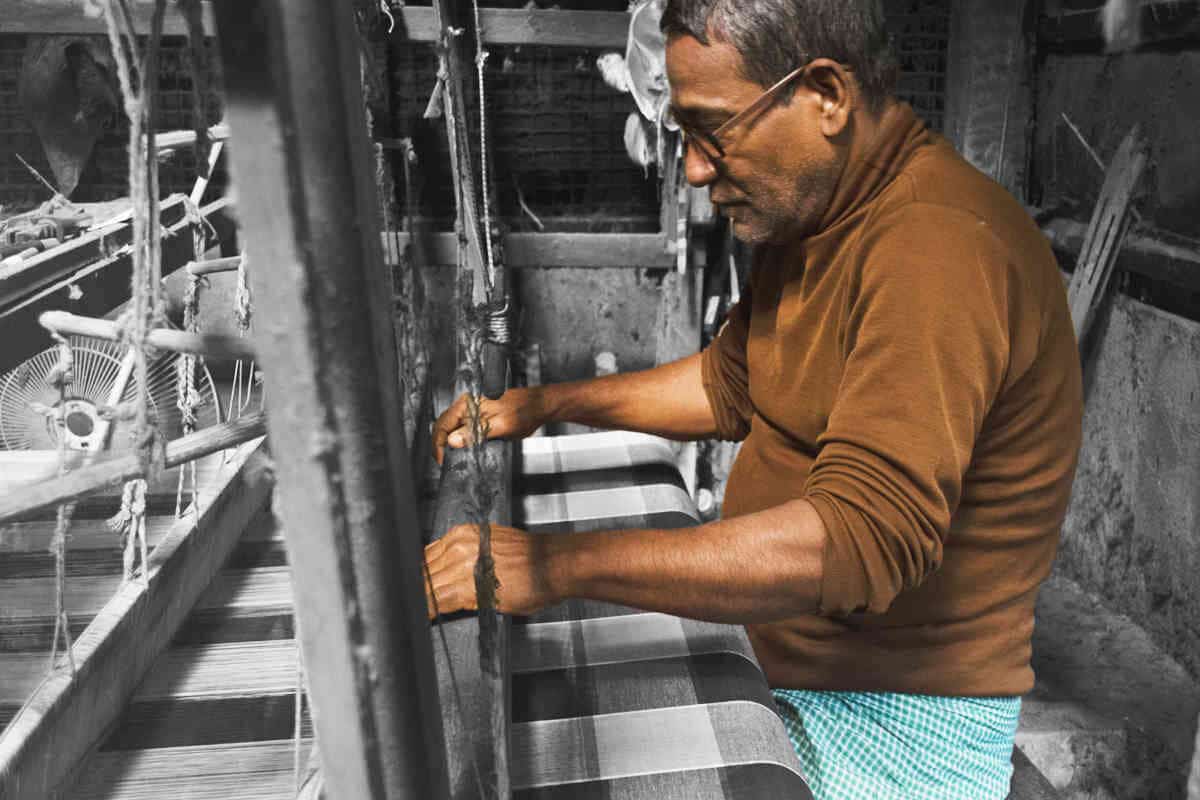 man working on textiles